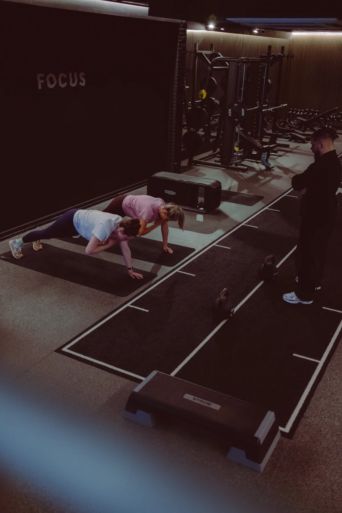 Duo training together on the BFZ floor, coach nearby