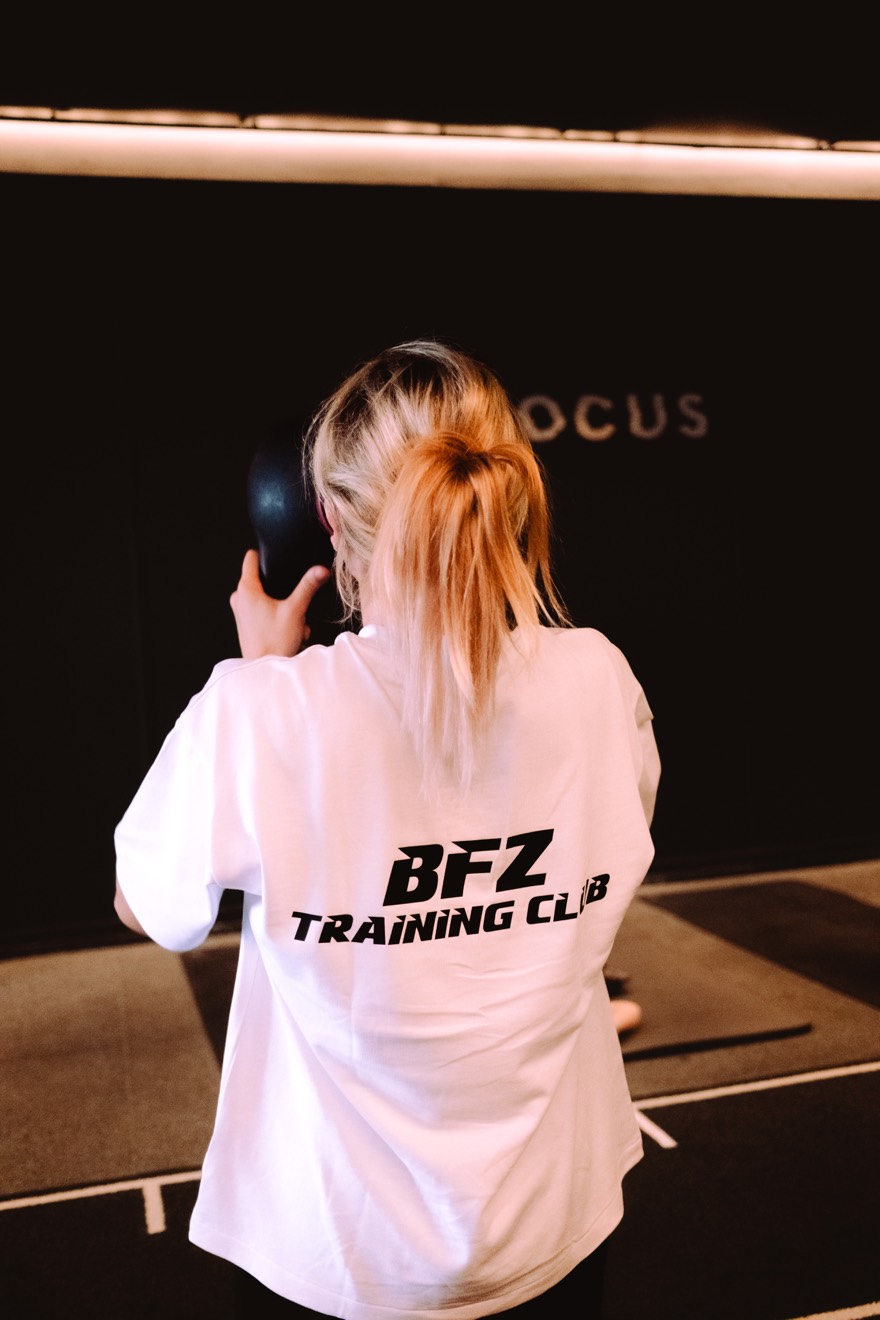 Member training with a kettlebell at the FOCUS wall