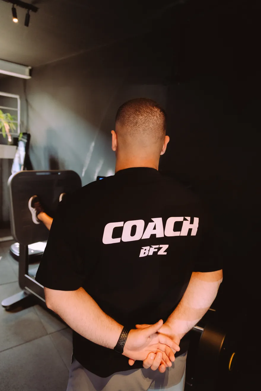 Coach in a BFZ COACH shirt on the club staircase